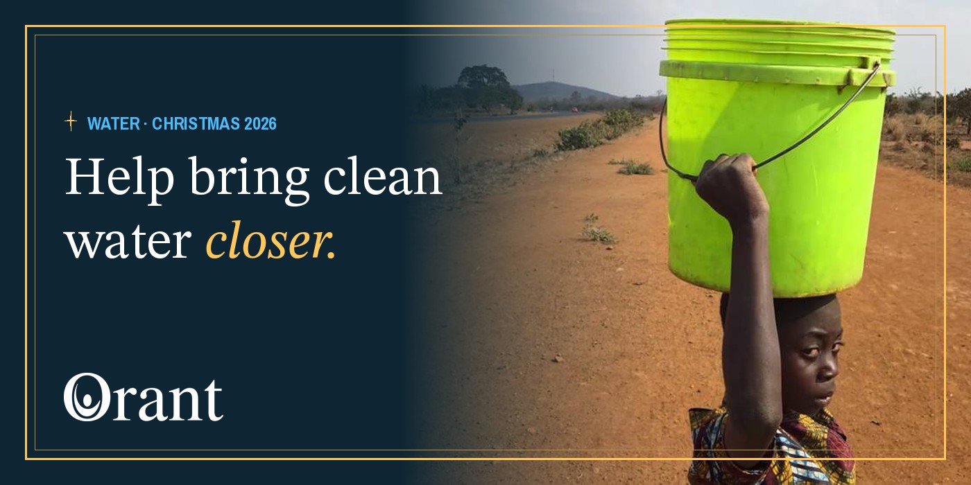 A child carries a water bucket on her head along a dirt road in Malawi. Help bring clean water closer.