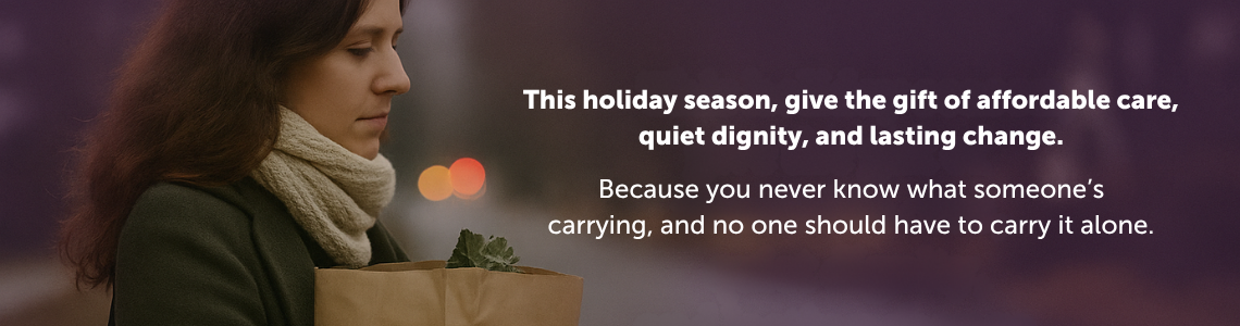 woman wearing a scarf carrying a bag of groceries