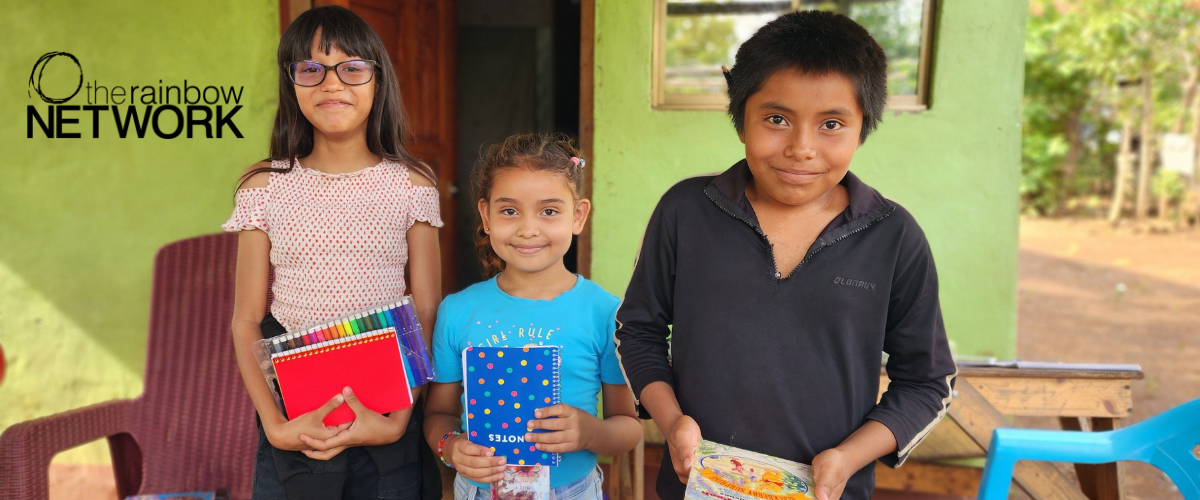 Three children holding notebooks