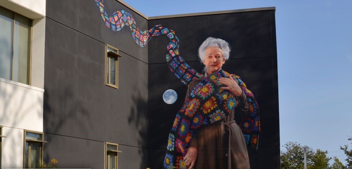 LAVC building with mural, "Freeway Lady" white-haired woman with colorful shawl, by celebrated artist Kent Twitchell