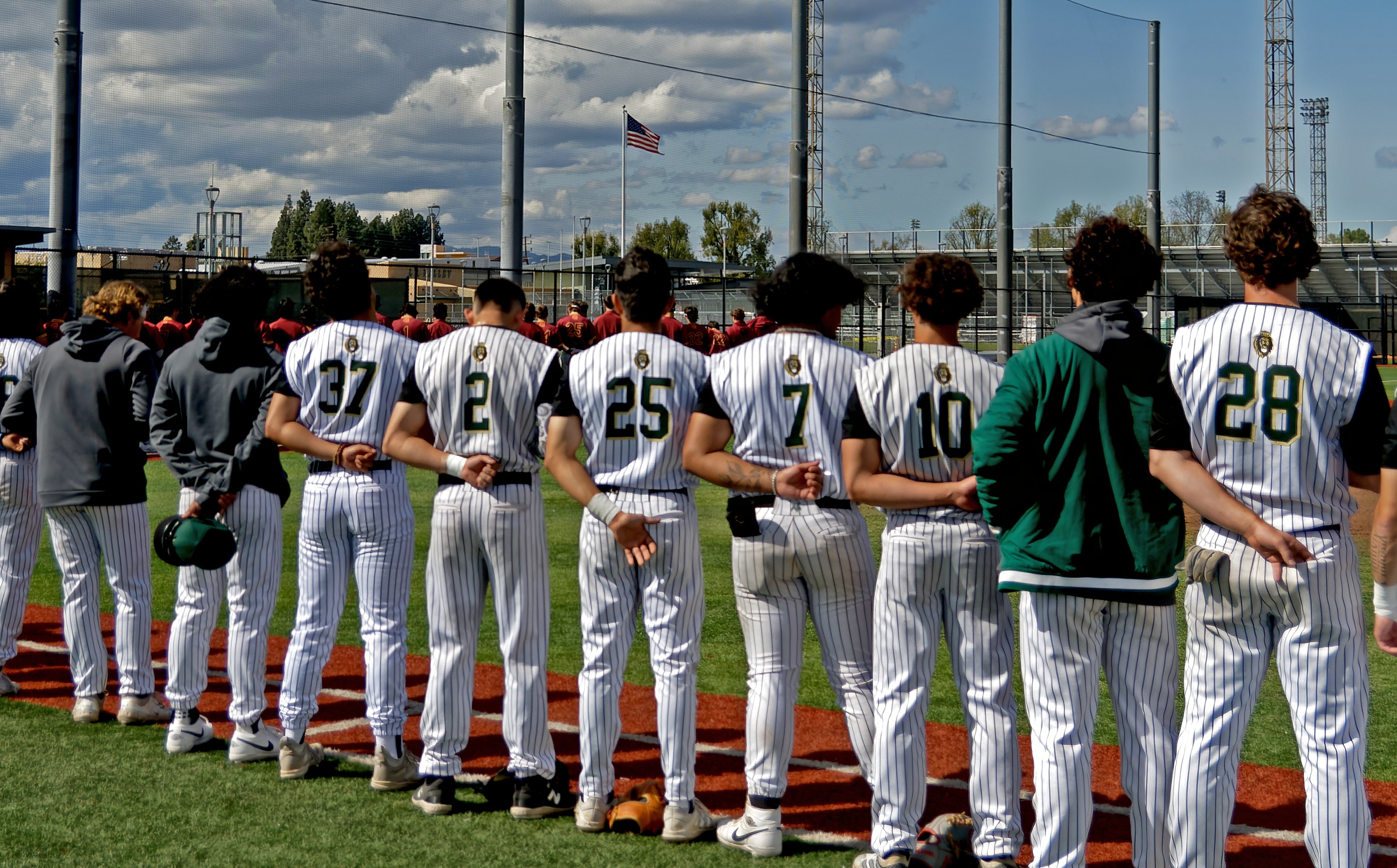LAVC baseball players standing in a row with their hands behind their backs