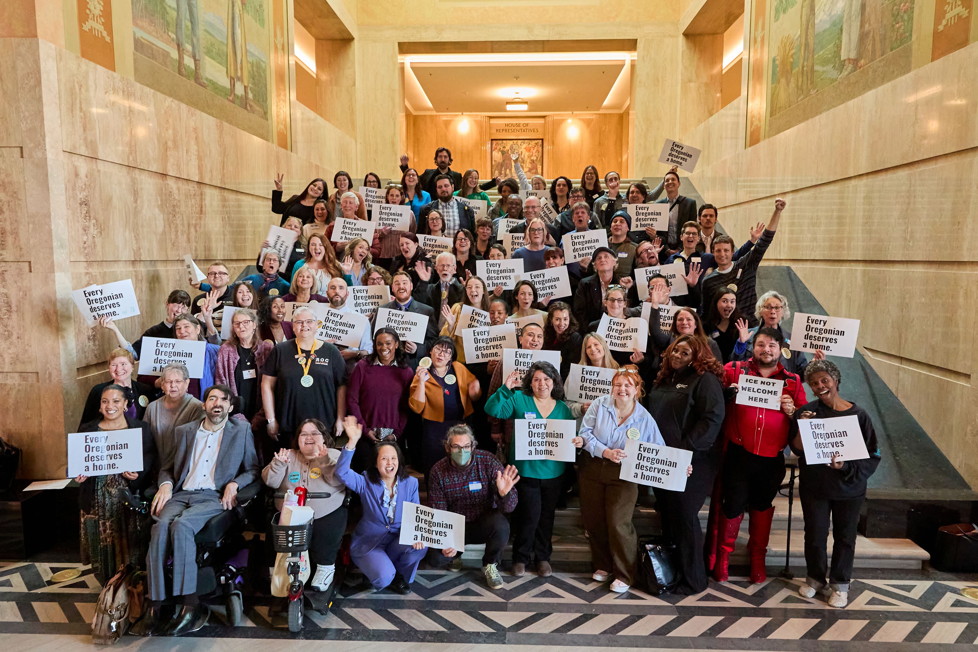 Housing Alliance members at the Oregon Capitol during lobby day, holding signs reading "Every Oregonian deserves a home."