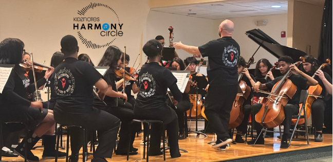 Orchestra students playing onstage; Kidznotes Harmony Circle Logo