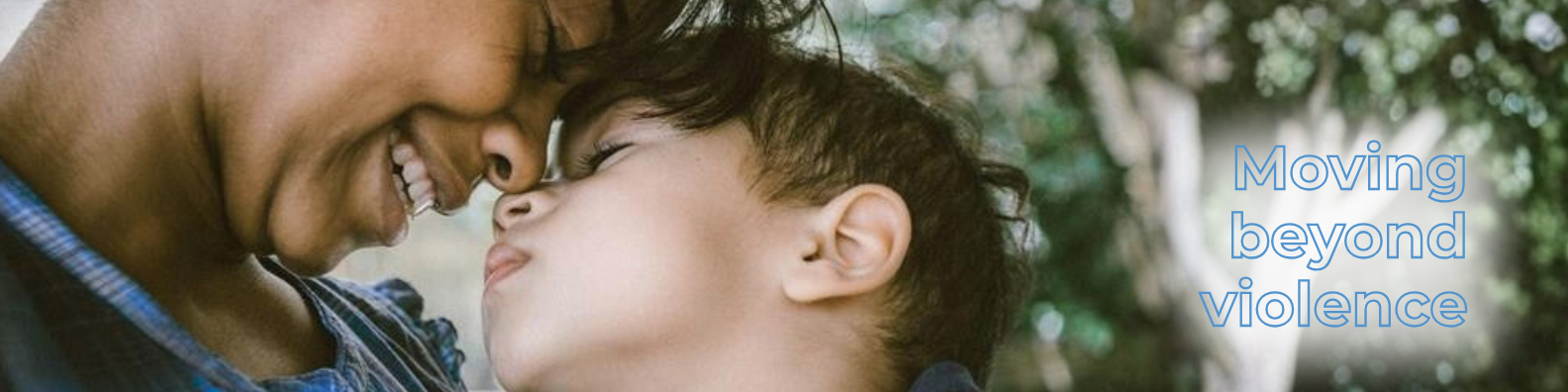 A women and child lean into eachother, text reads: Moving beyond violence.